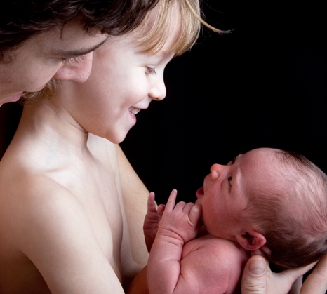 man boy and newborn in awe of life