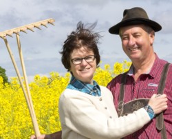 Farm couple enabling each other to taste a shared glory